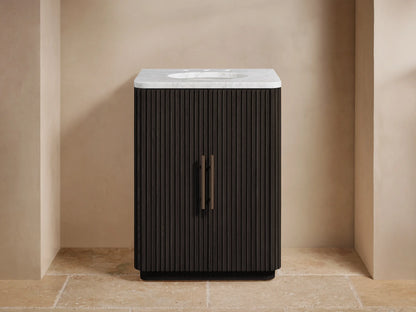 Dark fluted Finnley Powder Vanity with white marble top, dark bronze faucet and handles, in a light-colored bathroom.