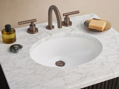 Finnley Powder Vanity, dark brown with fluted doors, white Carrara marble top, oval sink & bronze pulls.