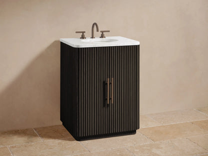 Finnley Powder Vanity: Dark fluted cabinet door partially open, revealing light beige towels and amber/white bottles on dark interior shelves.