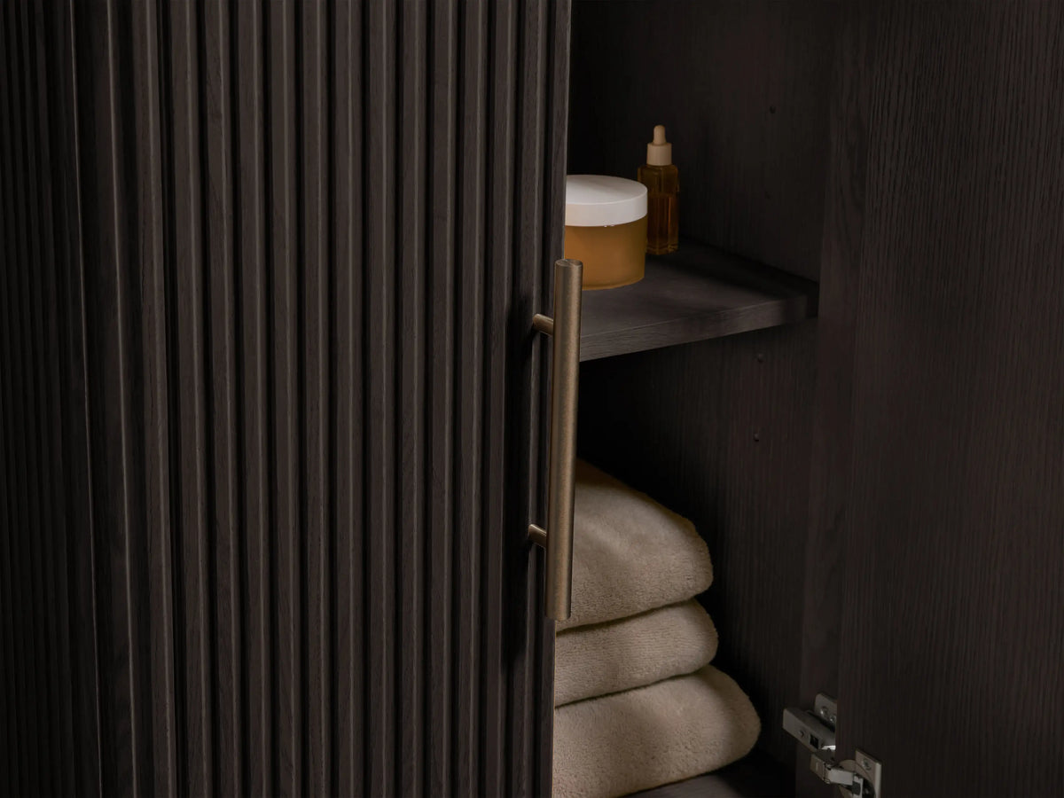 Finnley Powder Vanity with a white oval undermount ceramic sink set in a light marble countertop with prominent dark veining.