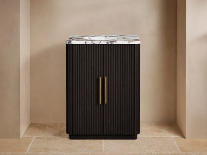 Finnley Powder Vanity: Dark brown ribbed wood vanity with white marble top, brass faucet, hardware, in a neutral room.