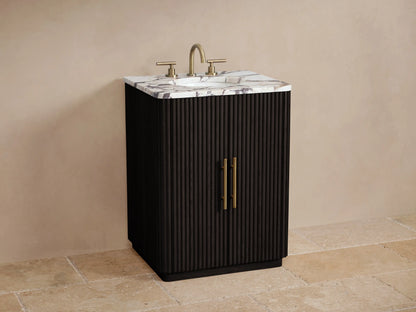 Finnley Powder Vanity: Dark fluted cabinet, brass bar pulls, and a white & purple veined marble top, on stone tile floor.
