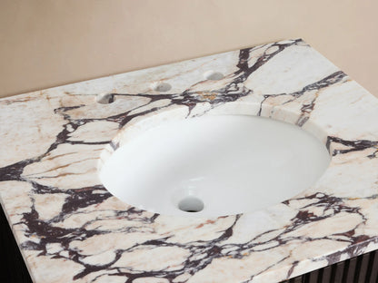 Finnley Powder Vanity, top-down view. Calacatta Viola marble with bold veining, white oval sink, brass faucet, accessories.