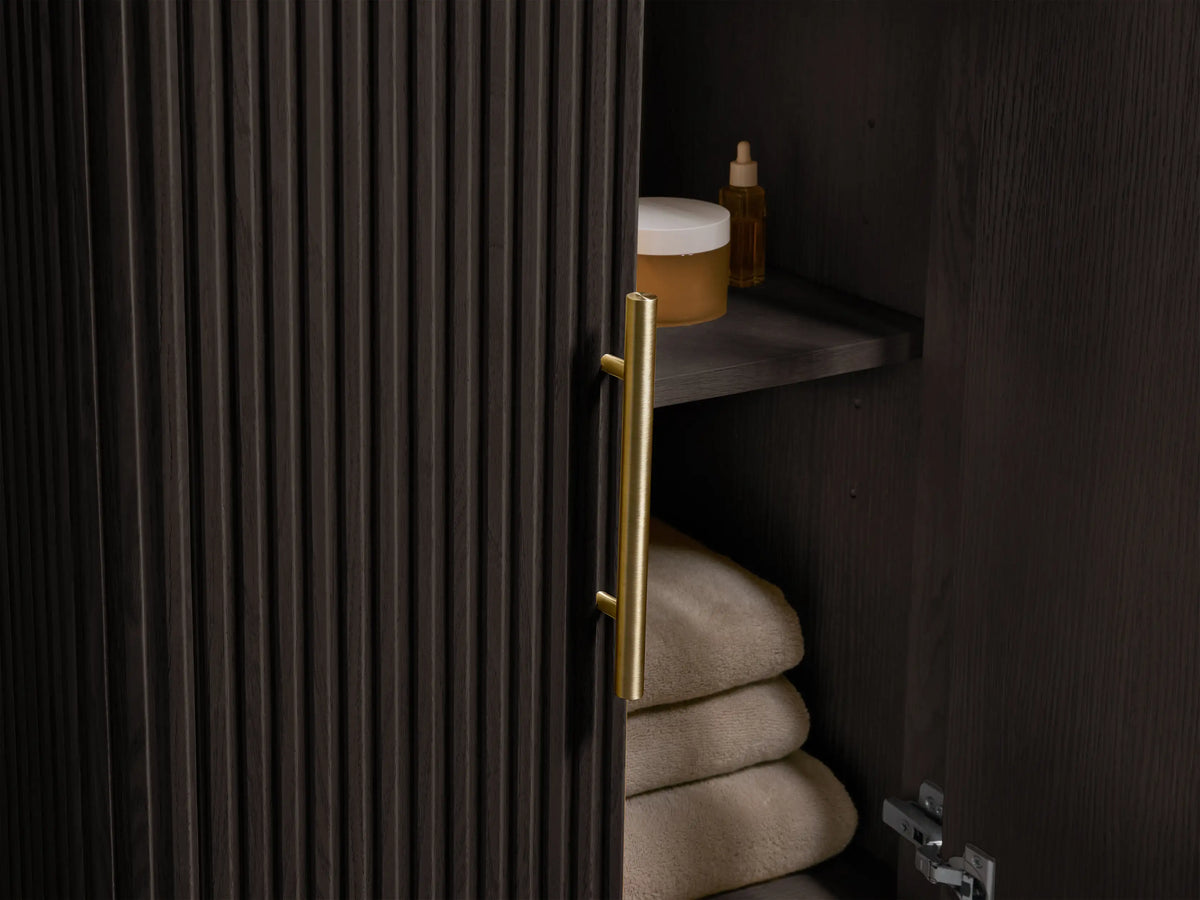 Close-up of Finnley Powder Vanity, showing a white oval undermount sink in a light marble top with dark veining and 3 faucet holes.