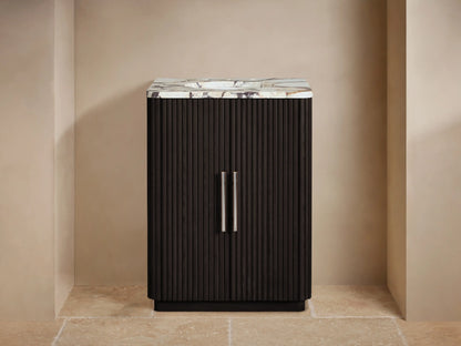 Finnley Powder Vanity with dark brown fluted doors, white veined marble top, chrome faucet & accessories in a neutral bathroom.