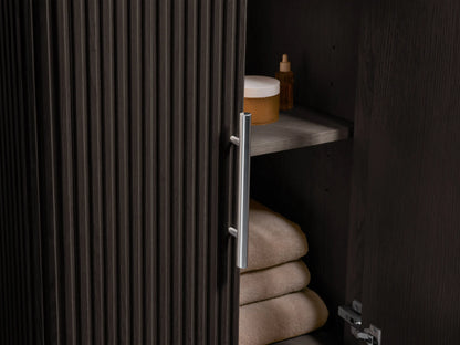 Angled close-up of Finnley Powder Vanity's oval white sink set in a cream, black, and gold veined marble countertop.