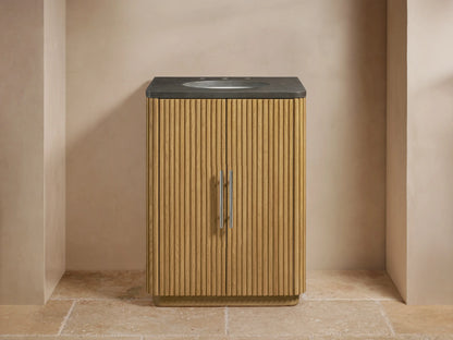 Vanity with vertical oak slat doors, stone top with mounted oval sink, polished nickel handles, and faucet in a neutral-tone bathroom.