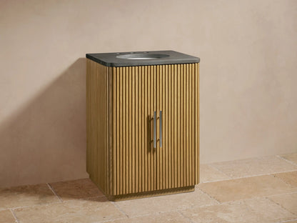 Finnley Powder Vanity with vertical oak slats, grey stone top, oval ceramic sink, mounted faucets, and silver handles.