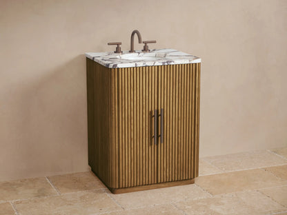 Finnley Powder Vanity, a light oak wood cabinet with vertical slats, white veined marble top, and dark handles.
