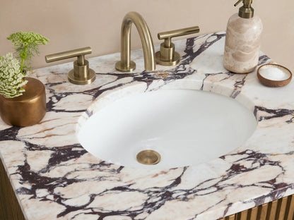 Finnley Powder Vanity: Oak wood vanity with vertical slats, white Calacatta Viola marble top, and antique brass handles.