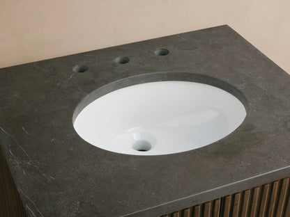 Close-up Finnley Powder Vanity with dark gray stone top, white oval sink, chrome faucet, and ribbed wood cabinet.
