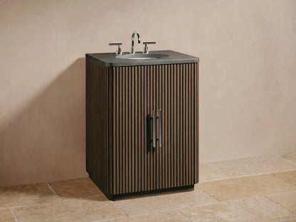 Close-up of Finnley Powder Vanity's fluted oak wood door, partially open to reveal shelves with cream jar, amber bottle, and towels.
