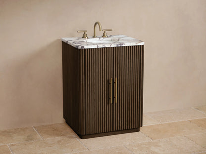 Finnley Powder Vanity, dark fluted oak wood with a veined marble top & antique brass pulls, full front view in a neutral room.