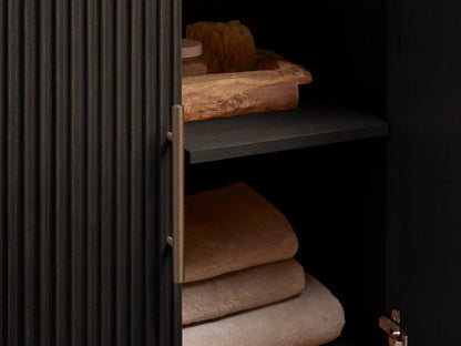 Close-up of Finnley Single Vanity: dark gray stone top, white oval sink, three faucet holes, and dark slatted wood side.