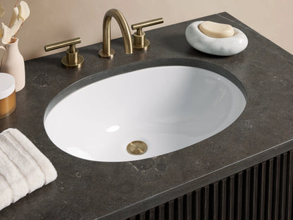 Dark oak wood Finnley Single Vanity with vertical slatted doors, brass handles, and a black stone top with an oval sink cutout.