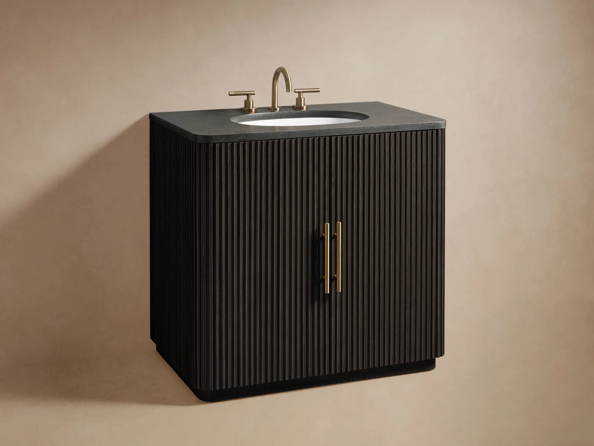 Open Finnley Single Vanity cabinet showing black ribbed door, antique brass handle, and shelves with towels and accessories.