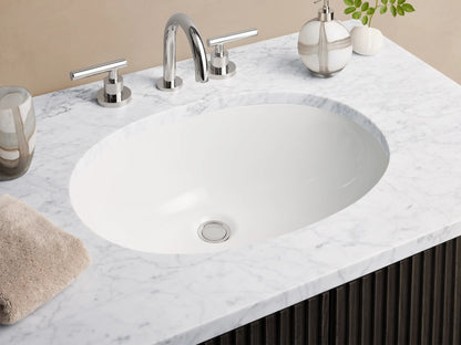 Black Finnley Single Vanity with a ribbed wood finish, silver handles, and a white stone countertop. Set on a beige tiled floor.