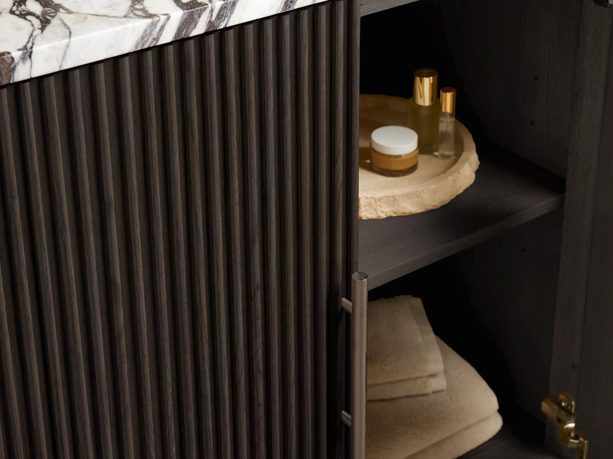 Close-up of Finnley Single Vanity with Calacatta Viola marble top, dramatic dark veining, oval white sink, and faucet holes.