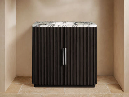 Finnley Single Vanity: dark brown fluted cabinet, white Carrara marble top with gray veins, chrome faucet & pulls.