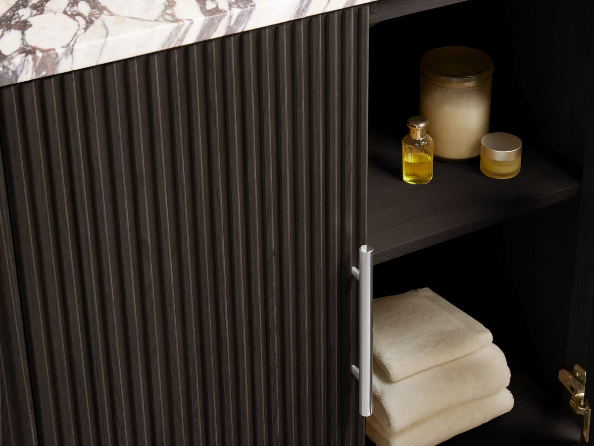 Finnley Single Vanity. White oval sink set in a cream, gray, and brown veined marble countertop with 3 faucet holes.