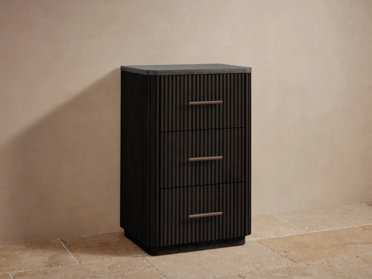 Close-up of Finnley Short Bath Cabinet's open dark wood fluted drawer with folded white towels and bronze pull handle.