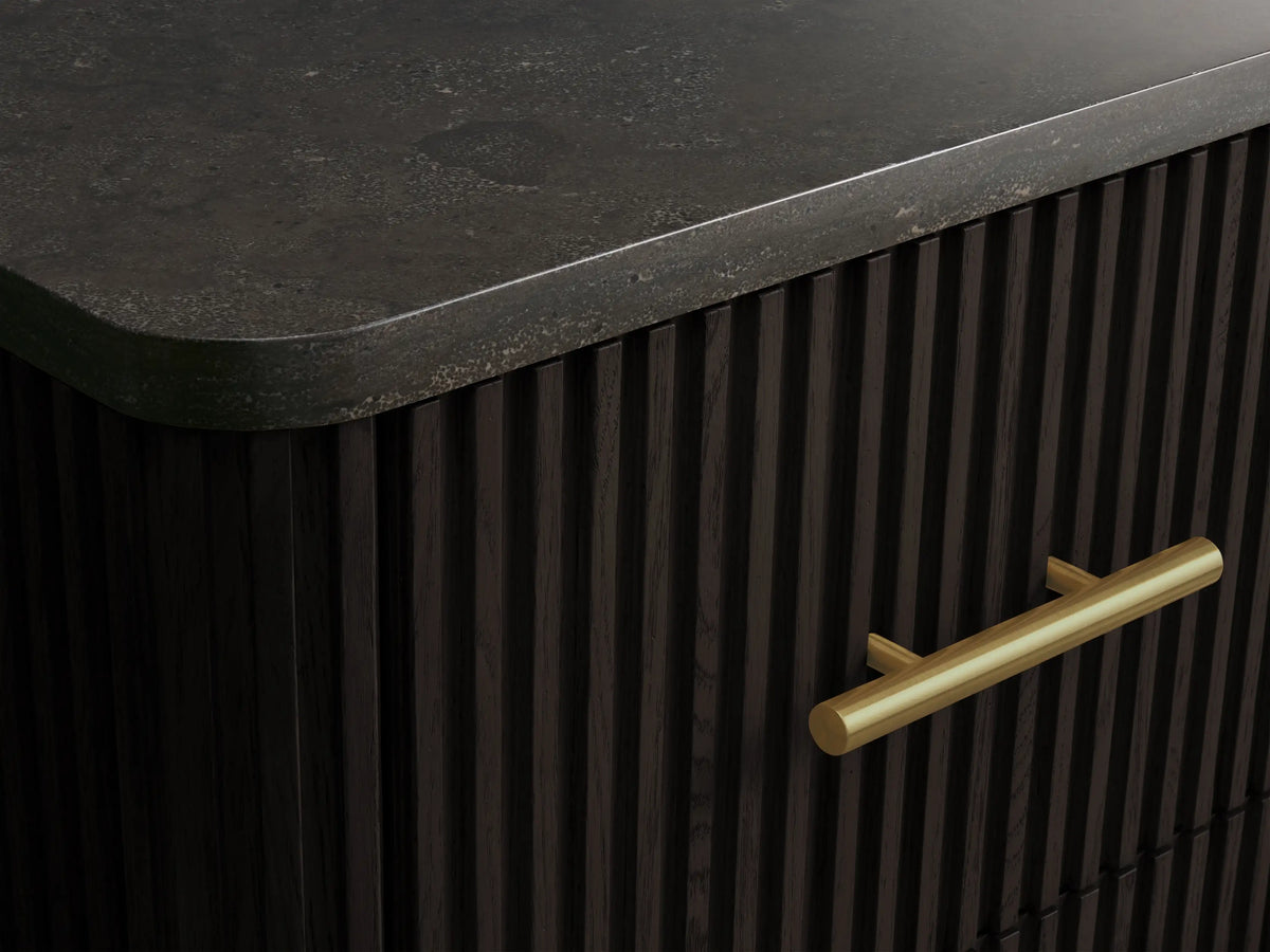 Close-up of Finnley Short Bath Cabinet: open dark wood fluted drawer with stacked white towels & a brass handle.
