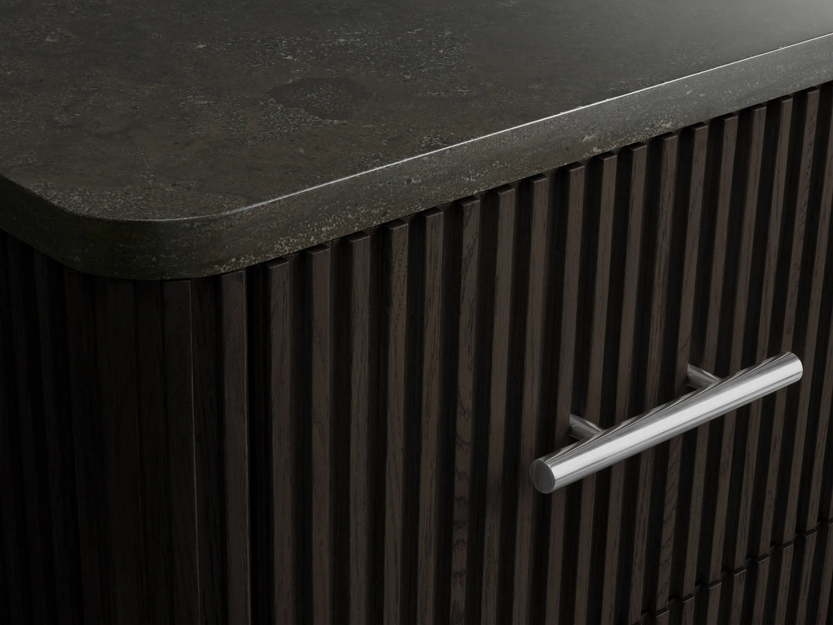 Close-up of Finnley Short Bath Cabinet's open dark reeded wood drawer, holding a stack of white towels, with a silver pull handle.