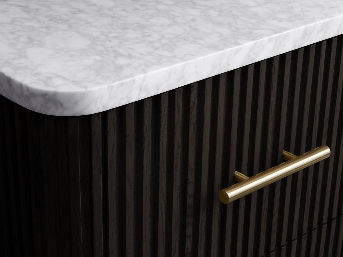 Finnley Short Bath Cabinet with a partially open dark fluted drawer containing white towels and a brass pull handle.