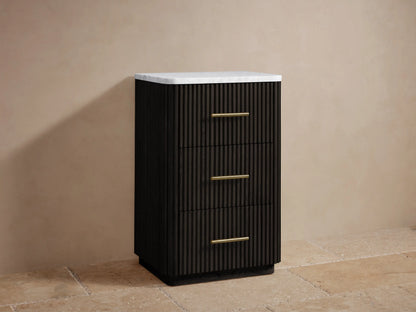 Close-up of Finnley Short Bath Cabinet. White Carrara marble top, dark fluted oak wood, and antique brass bar handle.