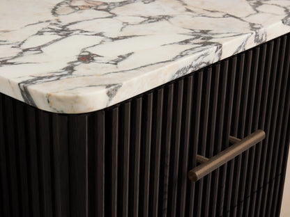 Finnley Short Bath Cabinet with dark ribbed wood, white marble top, and 3 drawers with antique brass pulls, on stone tiles.