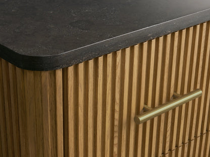 Finnley Short Etagere with open oak wood drawer showing folded white towels inside. Fluted texture and brass hardware visible.