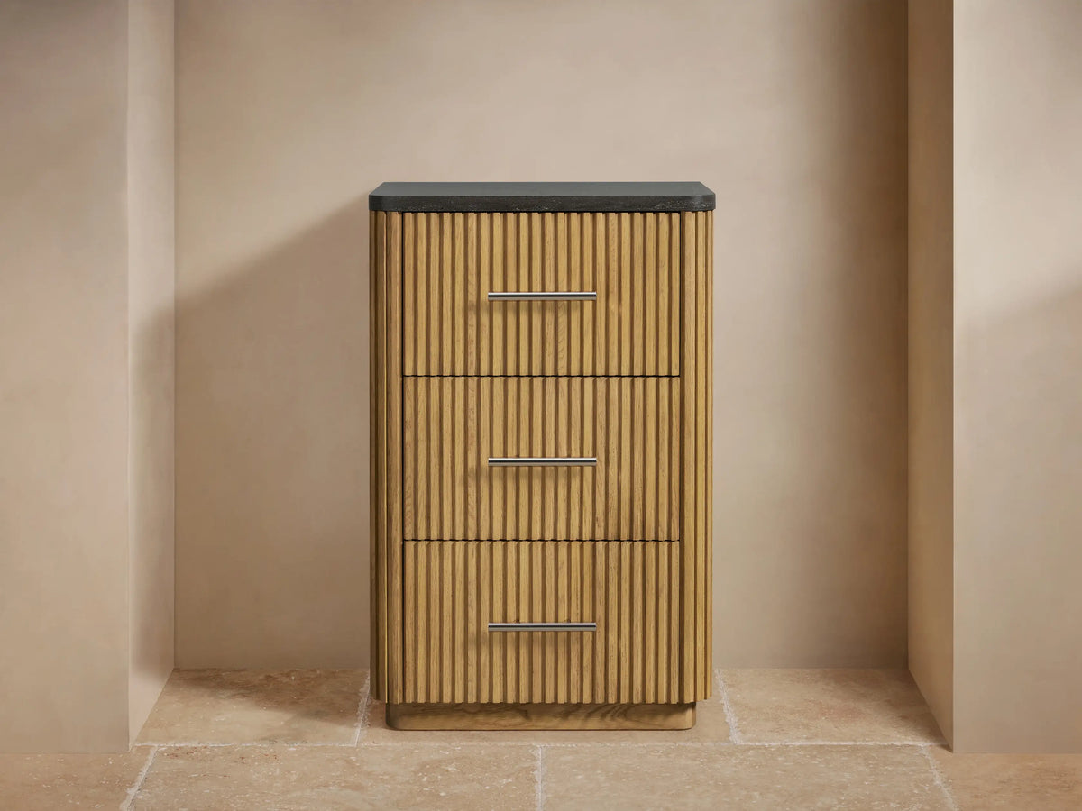 Close-up of Finnley Short Etagere showing ribbed oak wood texture with a smooth, dark stone top and metal drawer handle.