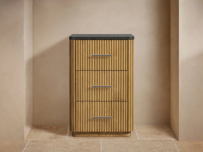 Close-up of Finnley Short Etagere showing ribbed oak wood texture with a smooth, dark stone top and metal drawer handle.