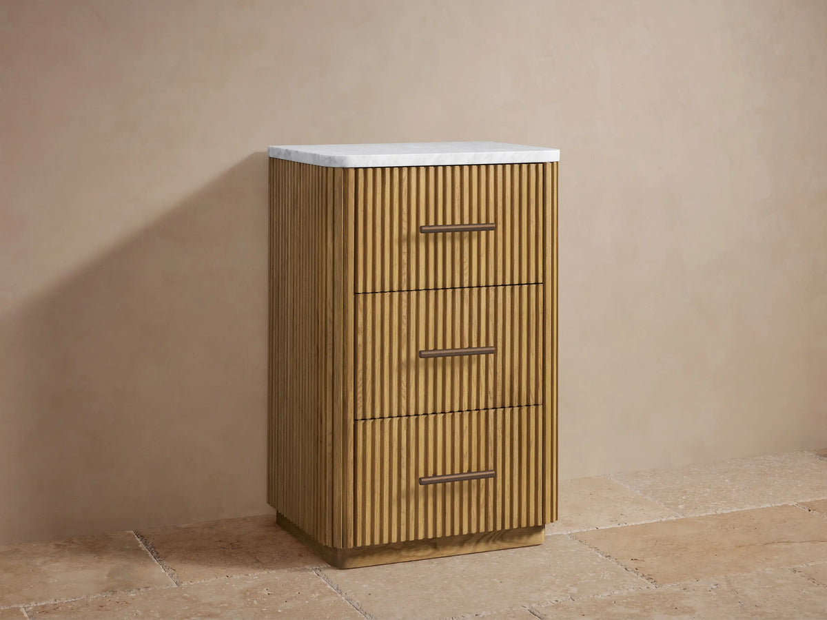 Close-up of Finnley Short Bath Cabinet open drawer with fluted oak wood front, showing white towels folded inside.