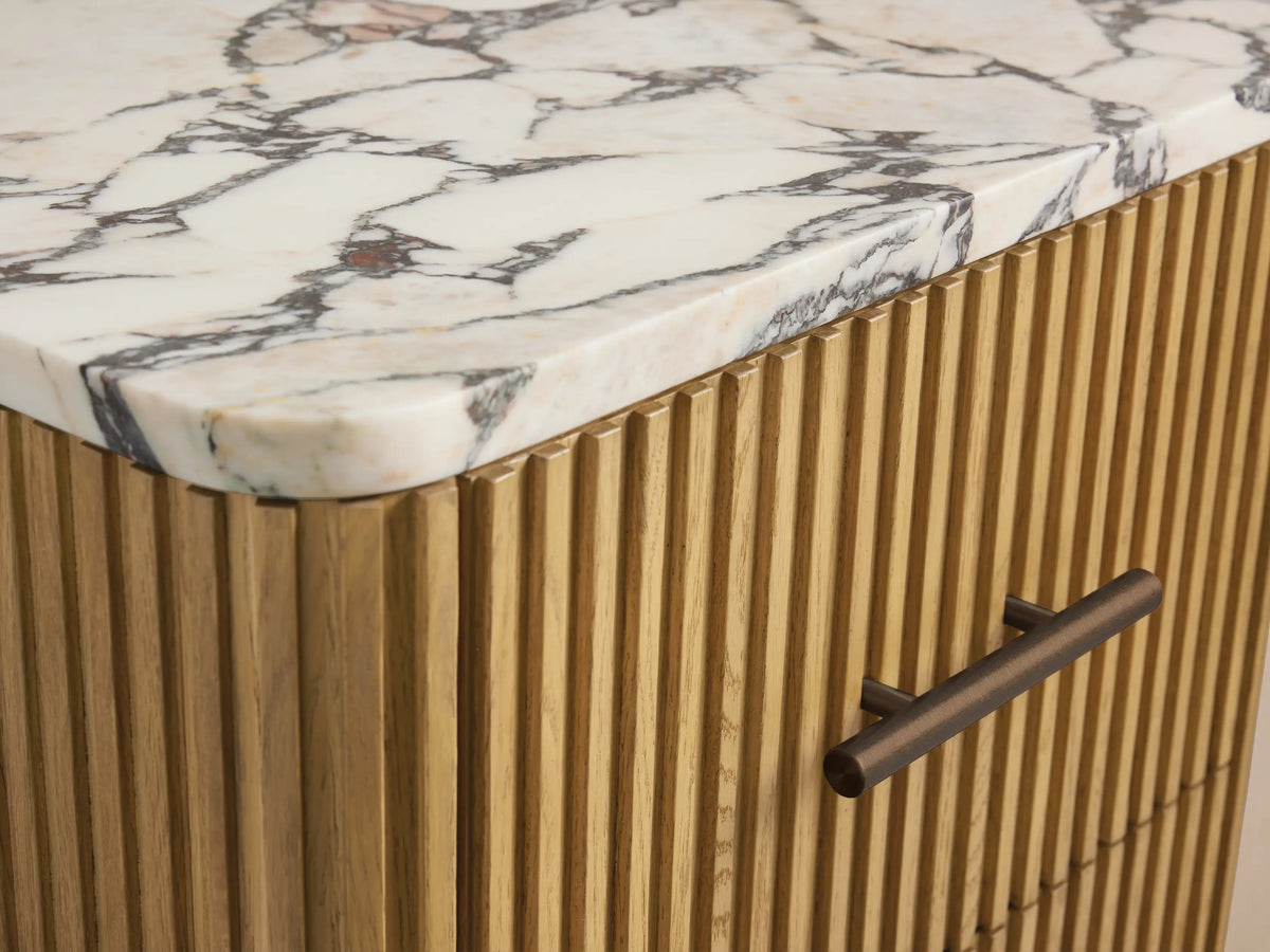 Finnley Short Bath Cabinet in light oak wood with vertical fluting, white Carrara marble top, and 3 drawers with bronze handles.
