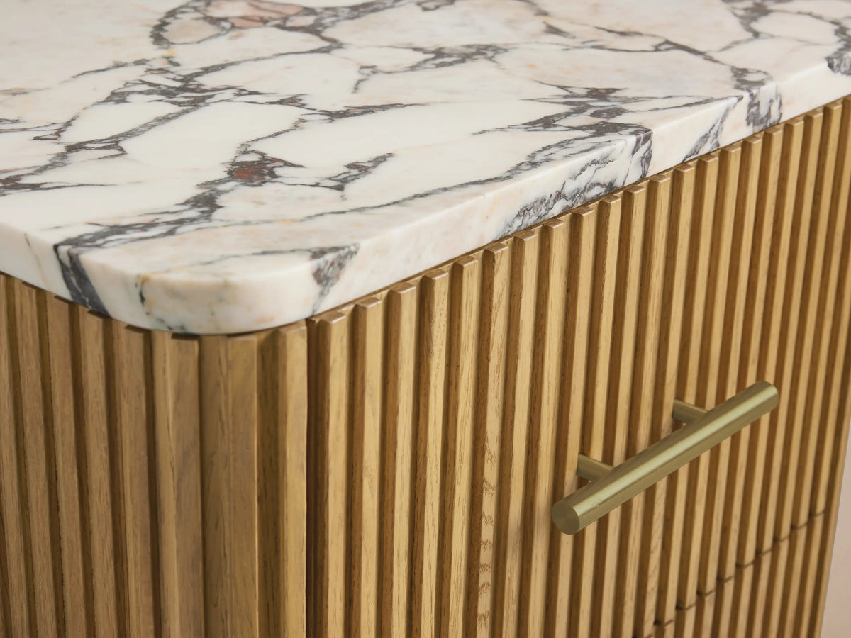 Close-up of Finnley Short Bath Cabinet: open light oak drawer with ribbed front, antique brass handle, and folded beige towels.