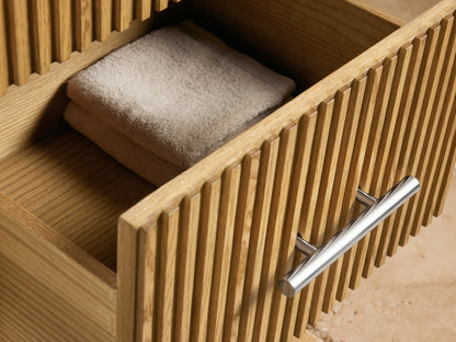 Close-up of Finnley Short Bath Cabinet; honed marble top with grey/pink veins, ribbed oak wood, and polished nickel handle.