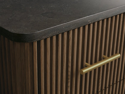 Finnley Short Bath Cabinet: Open oak wood drawer with ribbed front, holding neatly folded white towels, and a brass pull handle.