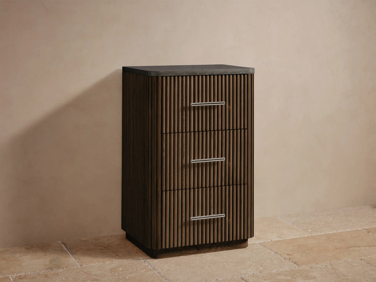 Open drawer of Finnley Short Bath Cabinet with slatted oak wood design, holding white towels and showing a polished nickel handle.