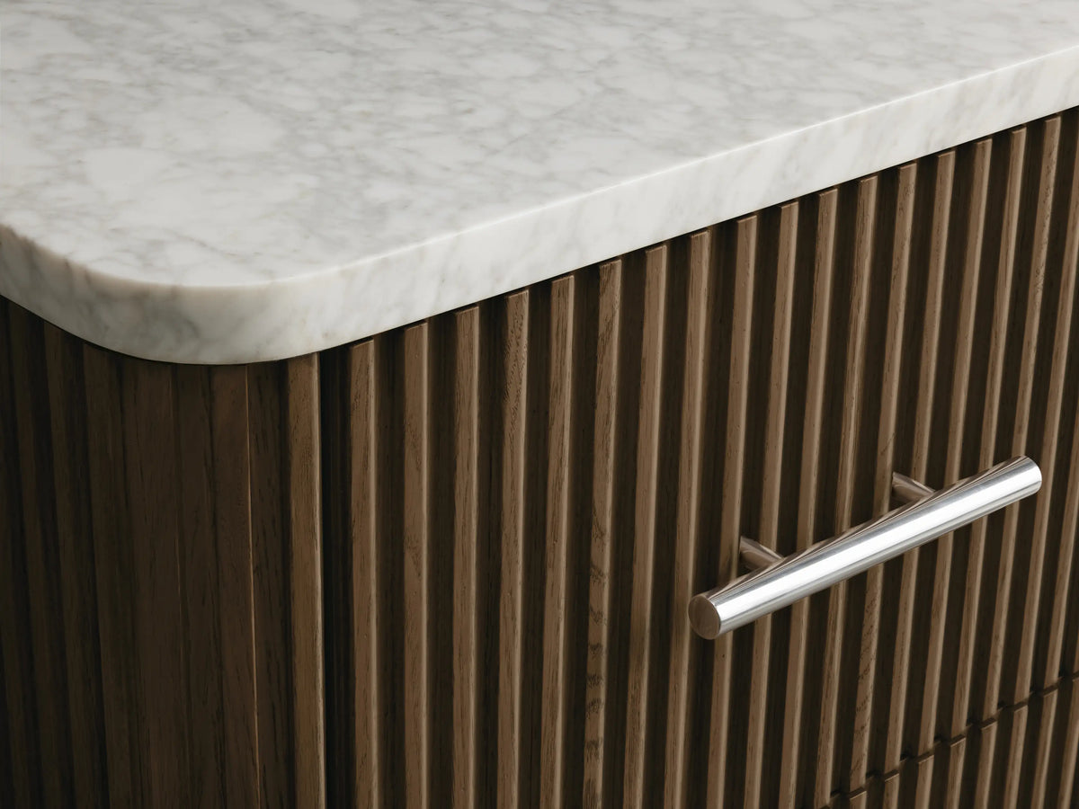 Finnley Short Bath Cabinet with dark brown fluted wood, white marble top, and three drawers with polished nickel bar handles.