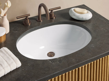 Finnley Single Vanity with oak wood fluted cabinet, dark gray stone top, oval white sink, and two doors with dark pulls.