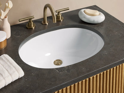 Oak wood Finnley Single Vanity with vertical slat design, black stone top, oval sink, brass faucet, and double brass handles.
