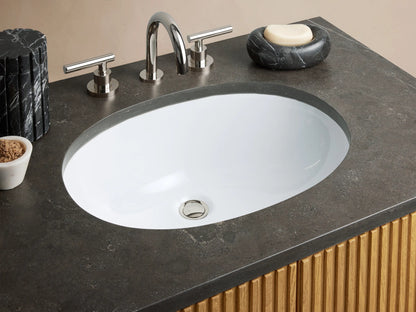 Finnley Single Vanity with vertical slatted oak wood doors, black stone top, and silver hardware in a beige tiled bathroom setting.