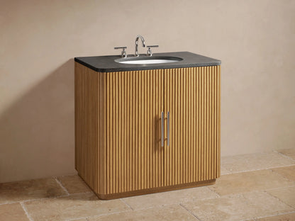 Open oak wood cabinet of the Finnley Single Vanity, revealing a removeable shelf with towels, wooden tray, and brush inside.