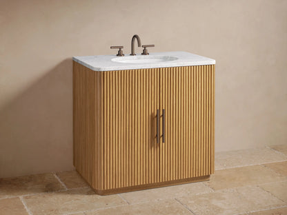 Close-up of Finnley Single Vanity's ribbed oak cabinet door slightly open, showing interior shelf with bath items and folded towels.