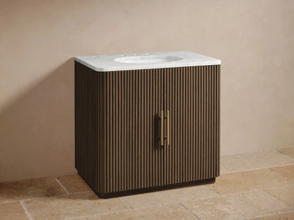 Finnley Single Vanity: Dark brown fluted wood cabinet, white marble top, oval sink, brass widespread faucet & handles.