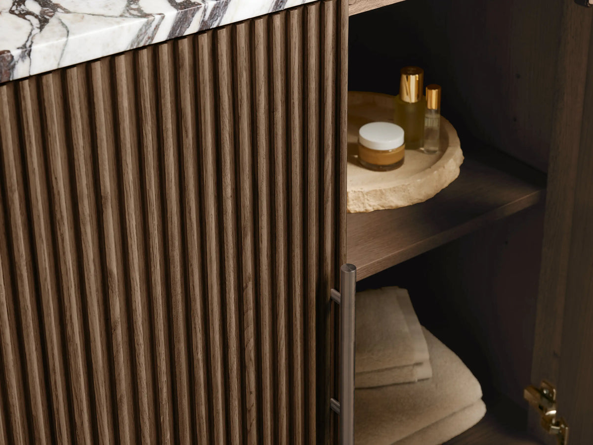 Close-up of Finnley Single Vanity top, white oval sink in cream marble with dark swirling veins, pre-drilled faucet holes.