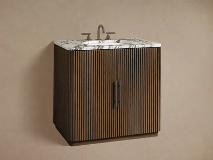 Close-up of Finnley Single Vanity with dark brown fluted wood, white marble top. Open cabinet reveals bottles, jar, and folded towels.