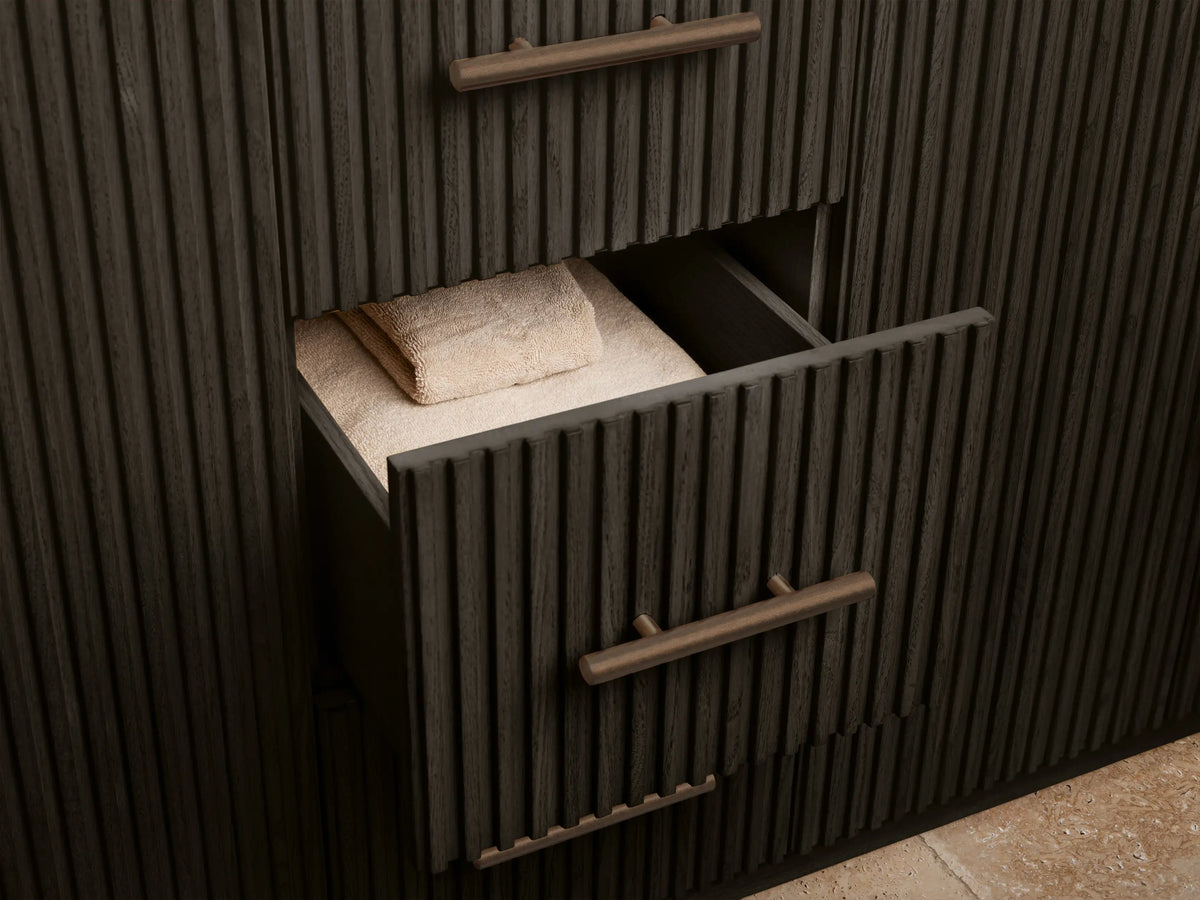 Finnley Wide Single Vanity dark wood cabinet, fluted door open, revealing a sponge in a bowl on a shelf & white towels.