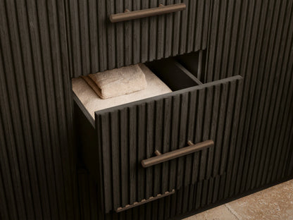 Finnley Wide Single Vanity dark wood cabinet, fluted door open, revealing a sponge in a bowl on a shelf & white towels.